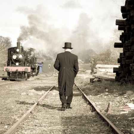 man walking on train track